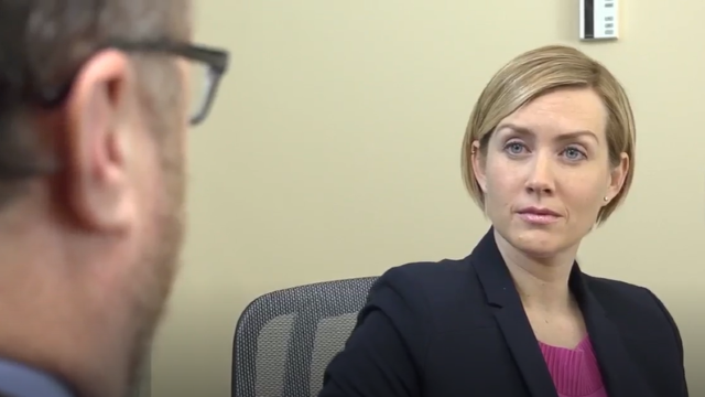 Female employee contemplating how to respond to rude coworker