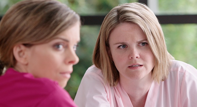 Two female healthcare workers engaged in gossip