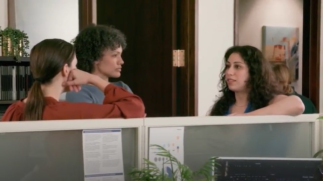 Three women having a conversation in the workplace