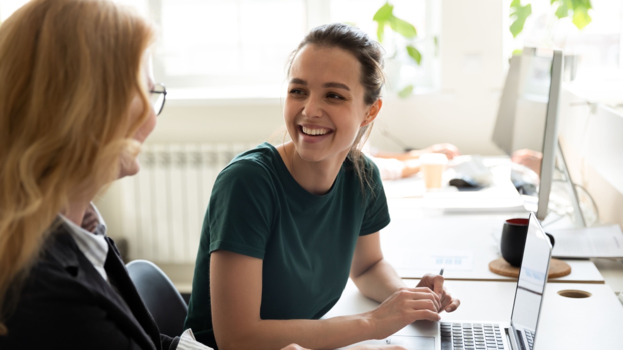 Happy female employee smiling as she is being trained