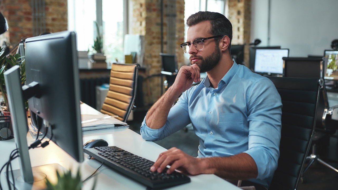 Man looking at computer, taking a training course