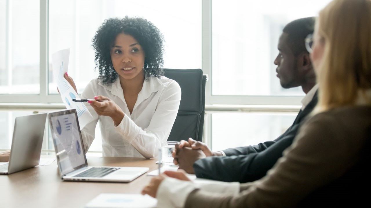 3 business leaders around a table looking at data