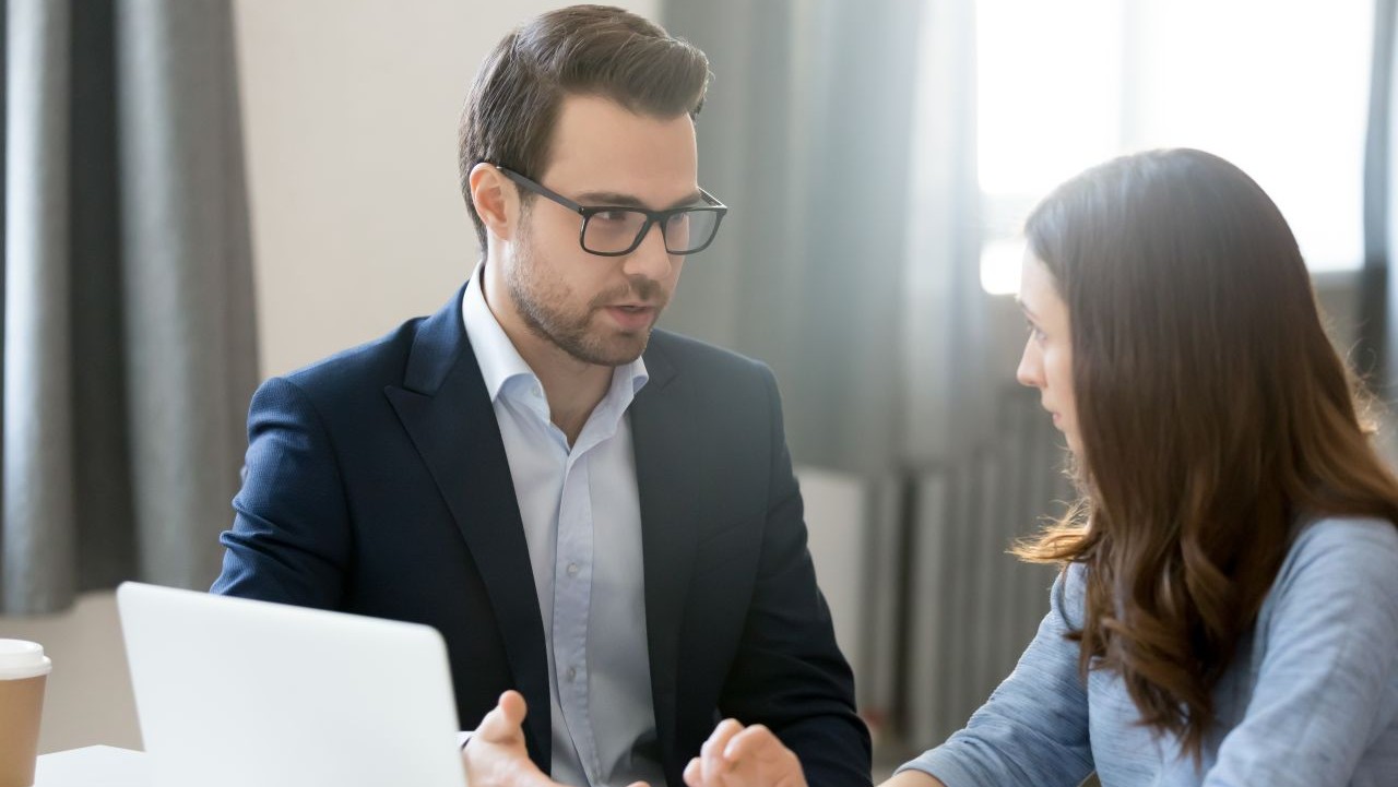 Female manager listening to male employee
